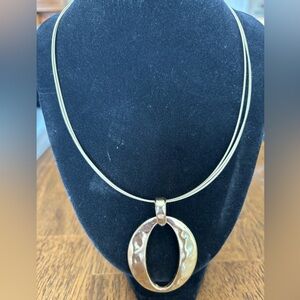 Dana Buchman gold tone necklace with large pendant